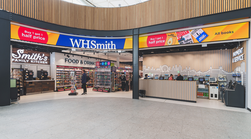 Bright WHSmith store interior with food displays, shelves, and a service counter.